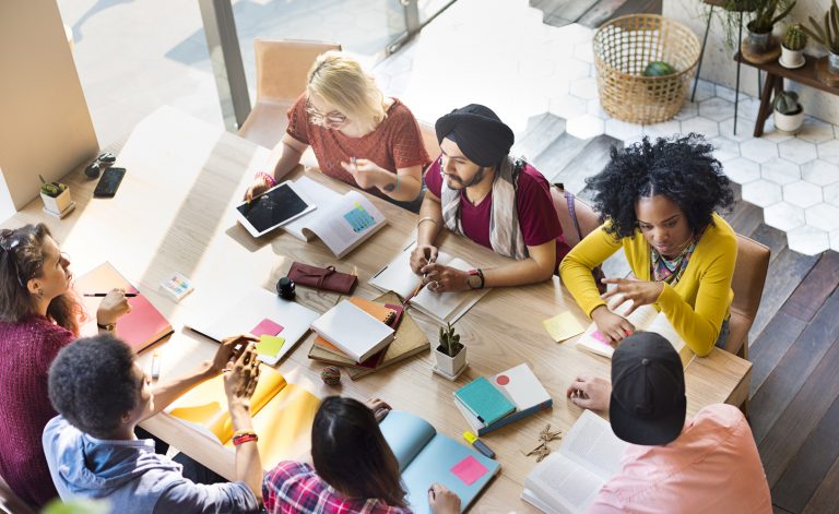 Pessoas diversas sentadas à mesa