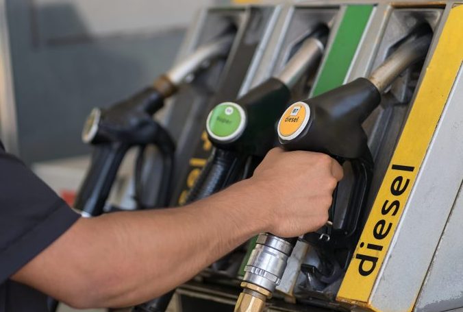 Homem segura uma bomba no posto de combustíveis